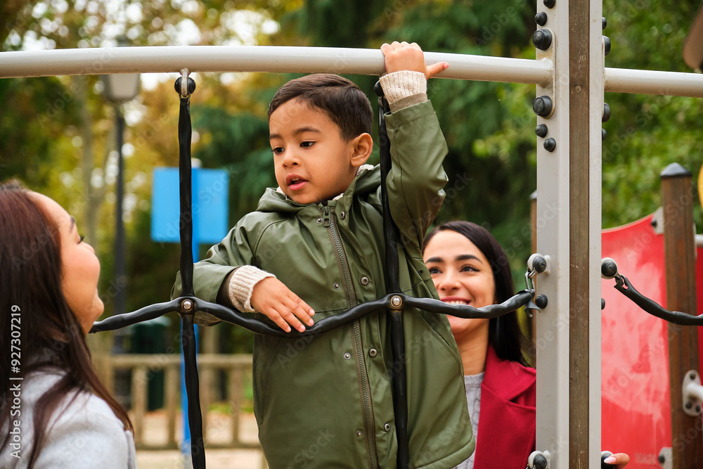 Latin lesbian couple playing with their son in the children's playground. LGBT family. Latin lesbian couple playing with their son in the children's playground. LGBT family.