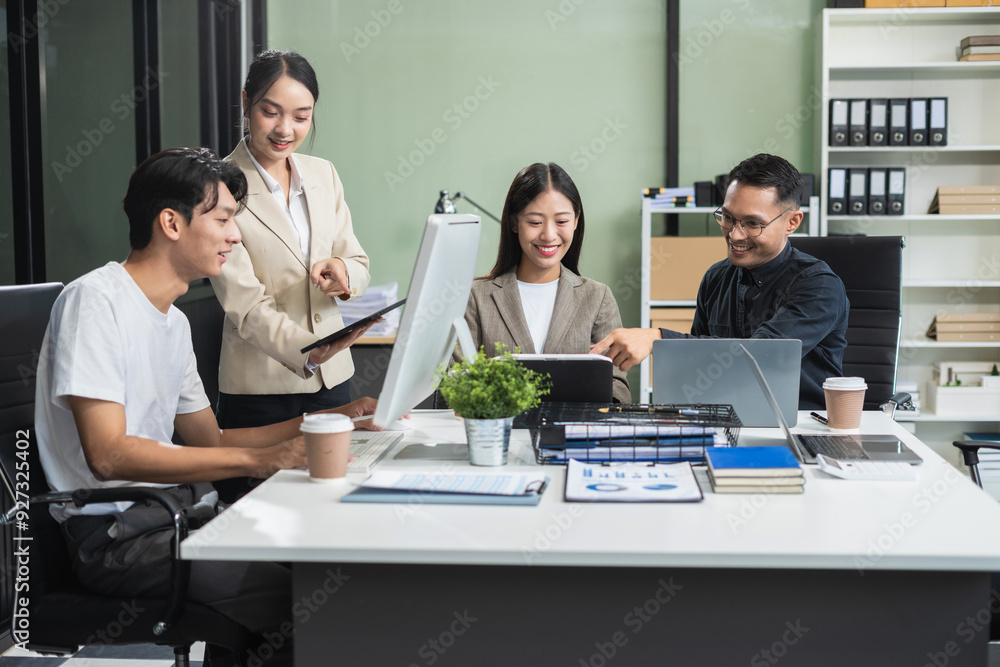 Business team working on a project in the office or reviewing and discussing a business project. Business team working on a project in the office or reviewing and discussing a business project.