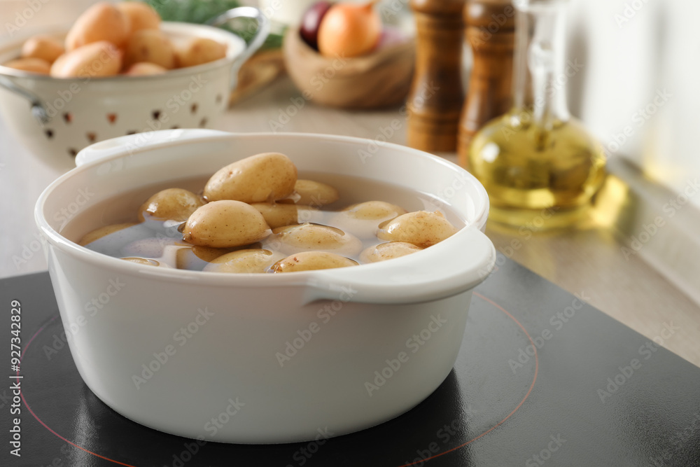 Boiling potatoes in pot on stove in kitchen Boiling potatoes in pot on stove in kitchen