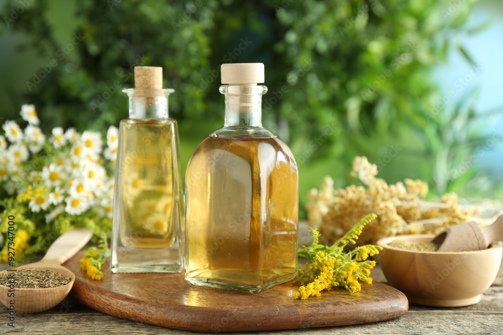Tinctures in bottles and medicinal herbs on wooden table Tinctures in bottles and medicinal herbs on wooden table