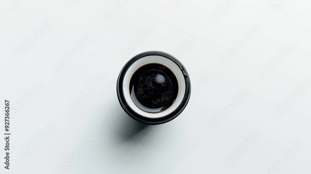Directly above shot of a plain black coffee mug on a white background
