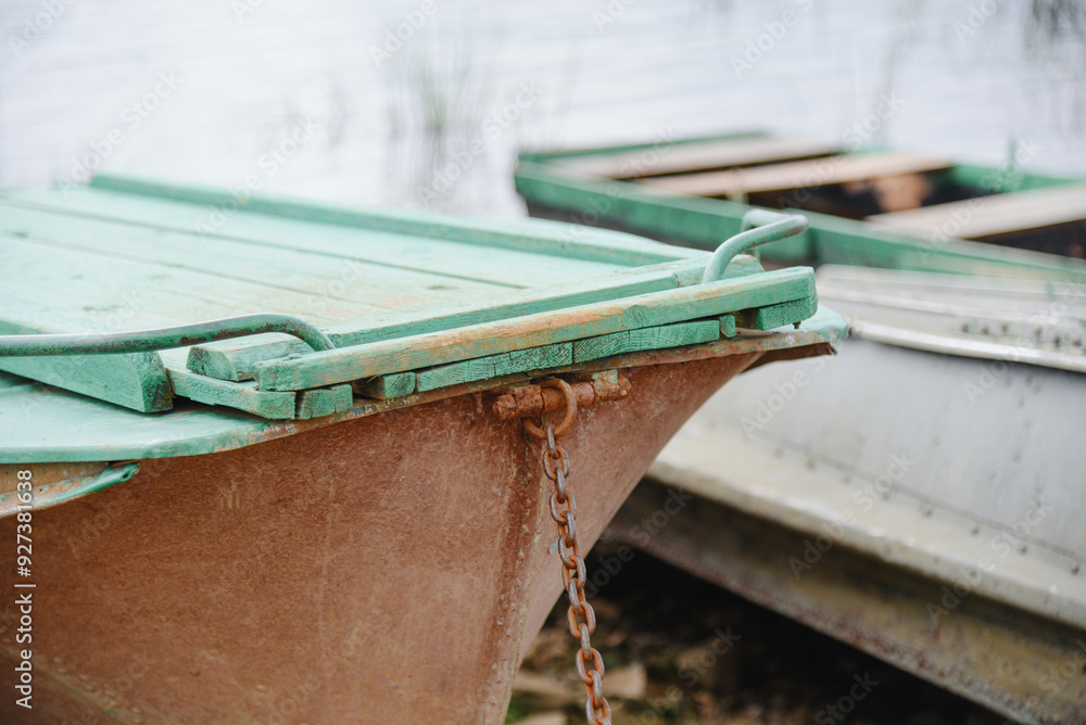 old wooden rowing boats in row on river bank old wooden rowing boats in row on river bank