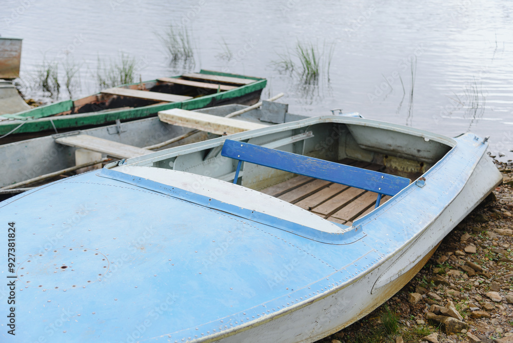 old wooden rowing boats in row on river bank old wooden rowing boats in row on river bank