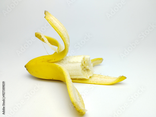 Half peeled and eaten banana, open banana isolated on white background.