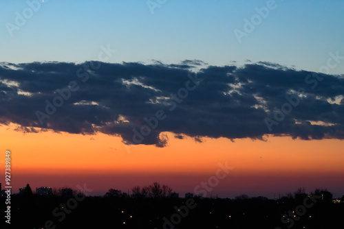 Cityscape in silhouette on a dramatic sunrise sky at dawn