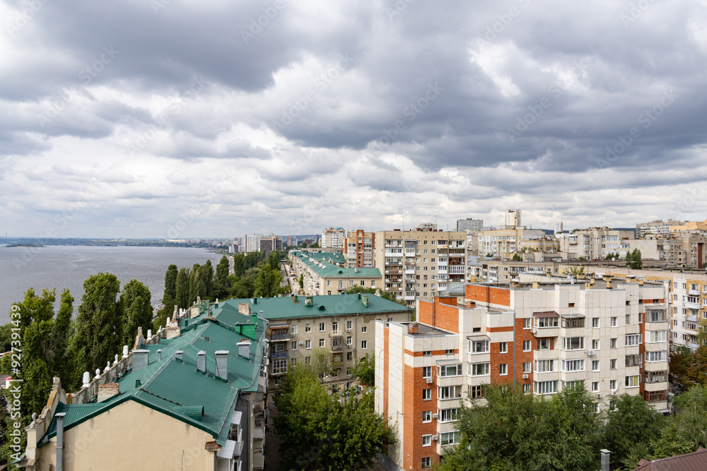 View of the city and the Volga River embankment from a height. A summer day, clouds in the sky. The city of Saratov, Russia View of the city and the Volga River embankment from a height. A summer day, clouds in the sky. The city of Saratov, Russia