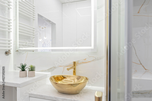 Elegenat and luxurious interior bathroom with marble tile and ceramic sink with golden faucet. Marble on the wall and walland mirror in stylish bath.	 photo