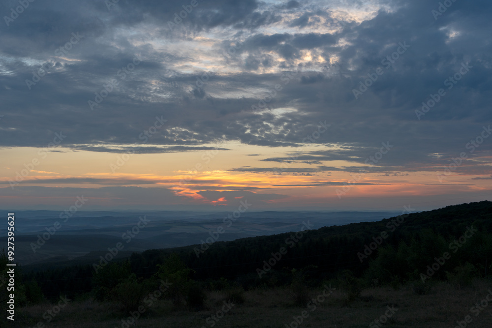 Fototapeta premium Sunrise over city and mountains