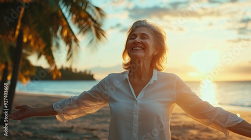Fototapeta Naklejka Na Ścianę i Meble -  Elderly lady in white shirt exuding joy on beach with palm trees and sun rays in backdrop