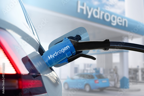 Close up of fuel cell car with connected hydrogen fueling nozzle. photo