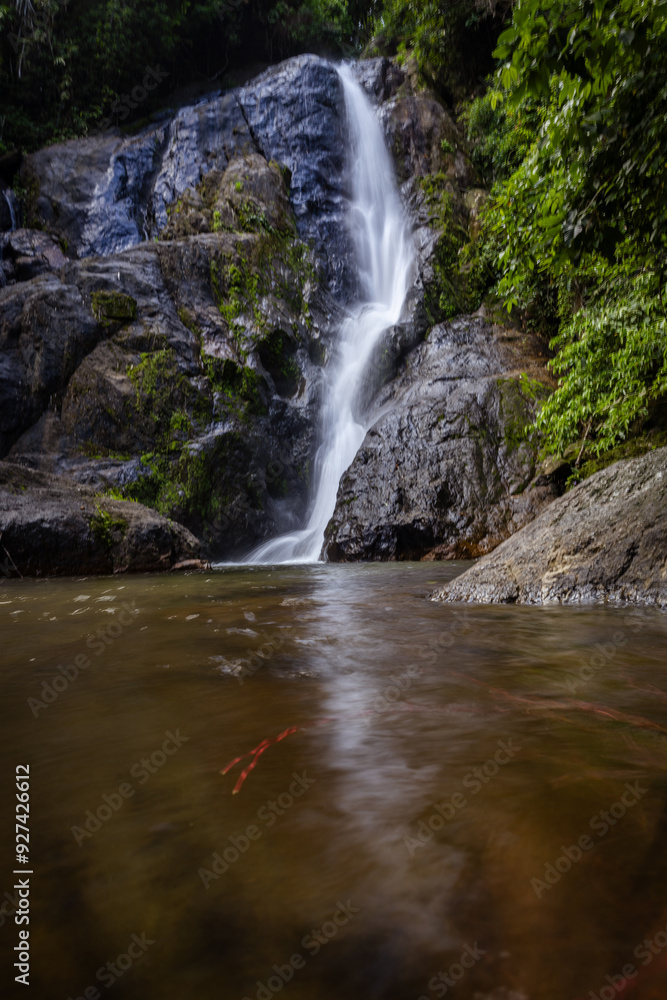 Waterfall in deep tropical rainforest with green rainy tree Waterfall in deep tropical rainforest with green rainy tree