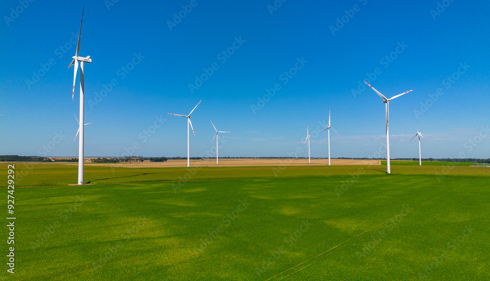 Windmills, wind power plant on a clear day Windmills, wind power plant on a clear day
