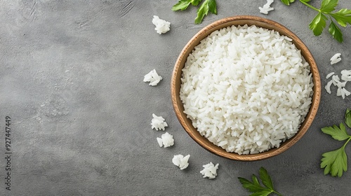 Bowl of tasty cooked rice on grey background, top view. Space for text --ar 16:9 --v 6.1 Job ID: b6d15d9d-efa9-4fcc-99a3-9d865371ddcd