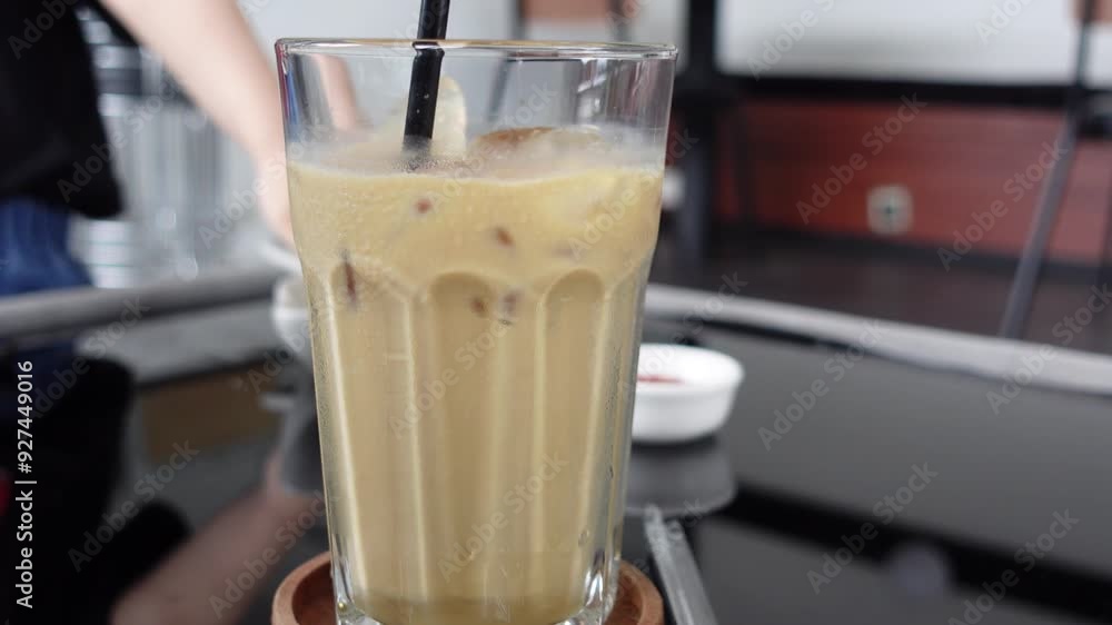 View of coffee in a transparent glass on a wooden tray View of coffee in a transparent glass on a wooden tray