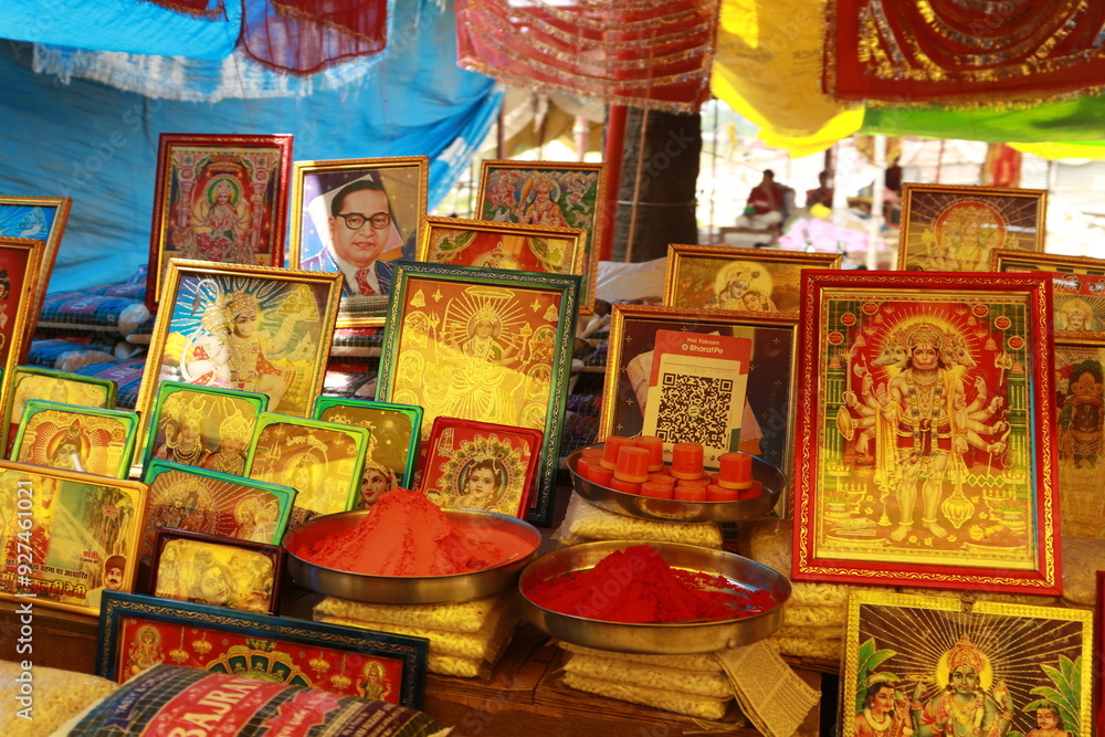 Naklejka premium Closeup picture of stalls of tarkulha devi mandir mela with decorative religious photos and chunni