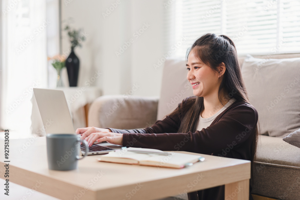 Happy Asian woman working from home. Happy Asian woman working from home.