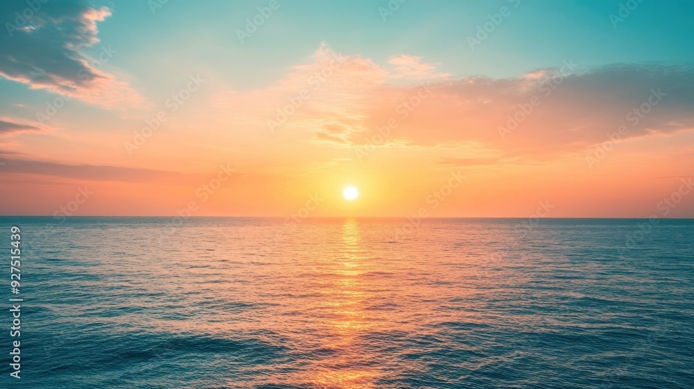 Obraz premium Sunset over the ocean with Peach Fuzz hues warm colors blend with the water creating a serene and captivating scene perfect for landscape photography