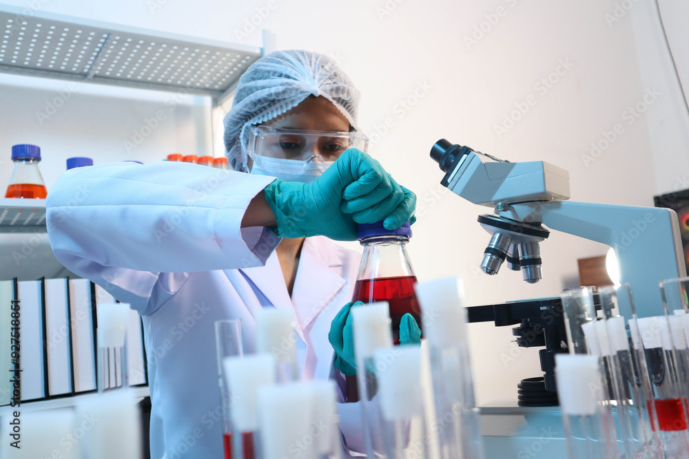 Scientists are testing medical drugs on a lab table. Scientists are testing medical drugs on a lab table.