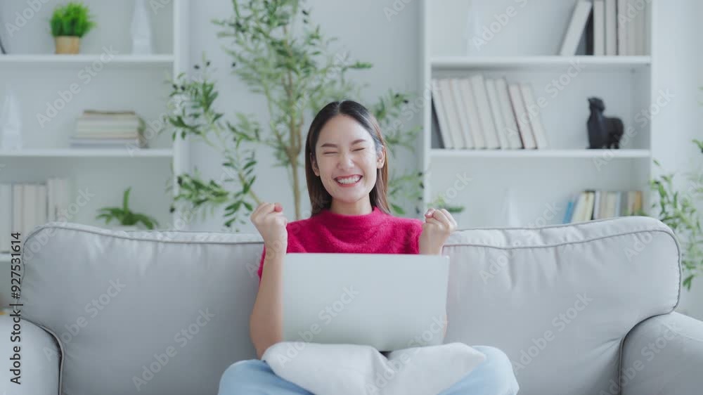 Happy euphoric young asian woman celebrating winning or getting ecommerce shopping offer on computer laptop. Excited happy girl winner looking at notebook celebrating success Happy euphoric young asian woman celebrating winning or getting ecommerce shopping offer on computer laptop. Excited happy girl winner looking at notebook celebrating success