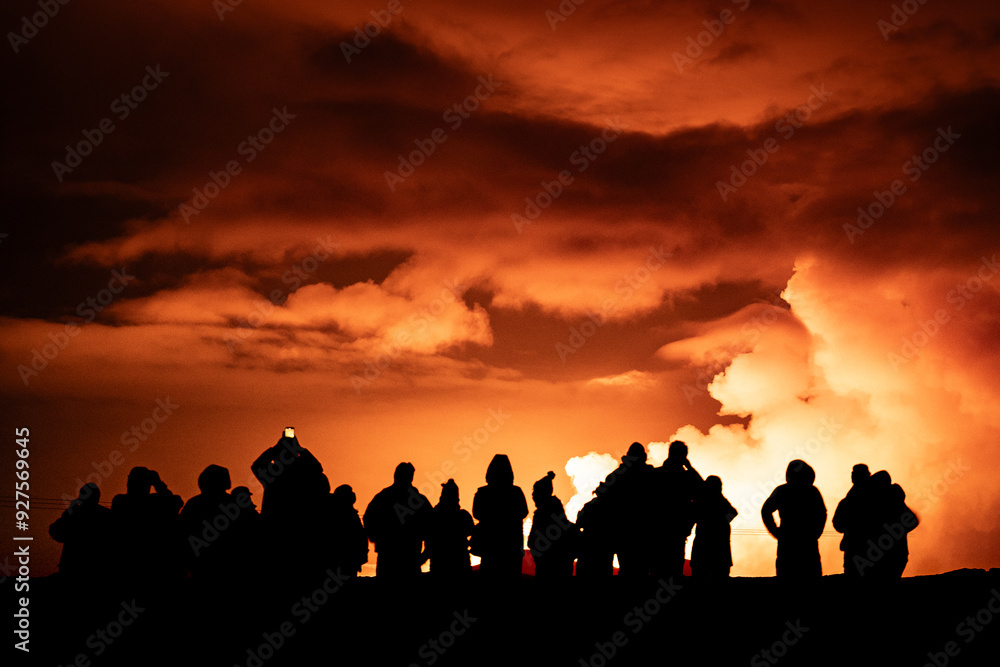 Group of people watching a volcanic eruption Group of people watching a volcanic eruption