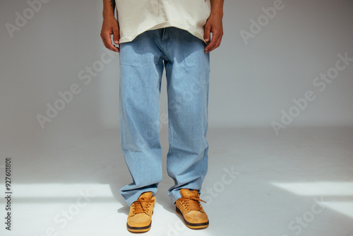 Obraz na płótnie Casual mens fashion showing modern light blue jeans design. The image highlights comfort and style of light denim in contemporary fashion for people. w salonie