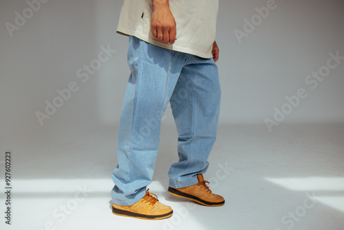 Obraz na płótnie Casual mens fashion showing modern light blue jeans design. The image highlights comfort and style of light denim in contemporary fashion for people. w salonie