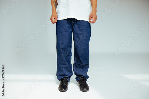 Fashion forward people concept with male model in well-fitted dark blue regular jeans. The design showcases comfort and style in everyday dark denim wear.