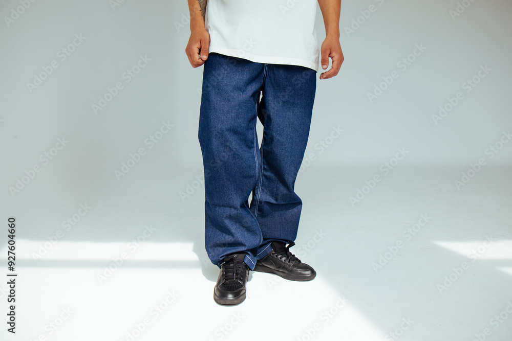 Fashion forward people concept with male model in well-fitted dark blue regular jeans. The design showcases comfort and style in everyday dark denim wear.