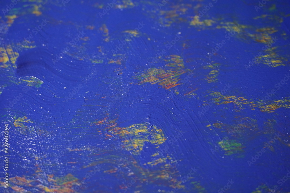 Mixed rough paint splatter on a textured blue paint surface, Grungy colorful paint brush strokes backdrop, Abstract multicolor paint splash background Mixed rough paint splatter on a textured blue paint surface, Grungy colorful paint brush strokes backdrop, Abstract multicolor paint splash background