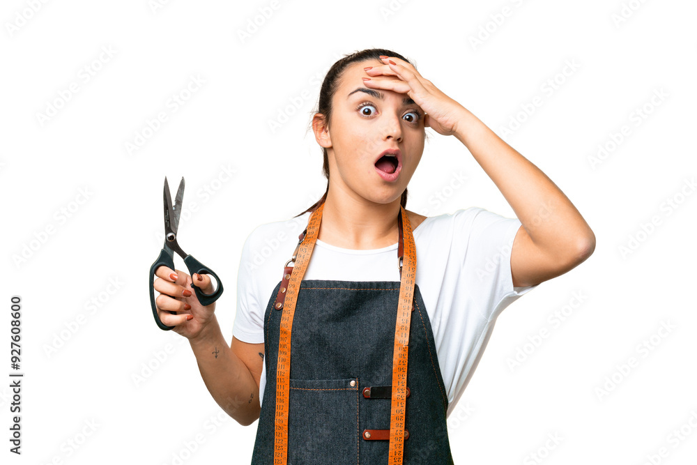 Seamstress woman over isolated chroma key background doing surprise gesture while looking to the side Seamstress woman over isolated chroma key background doing surprise gesture while looking to the side