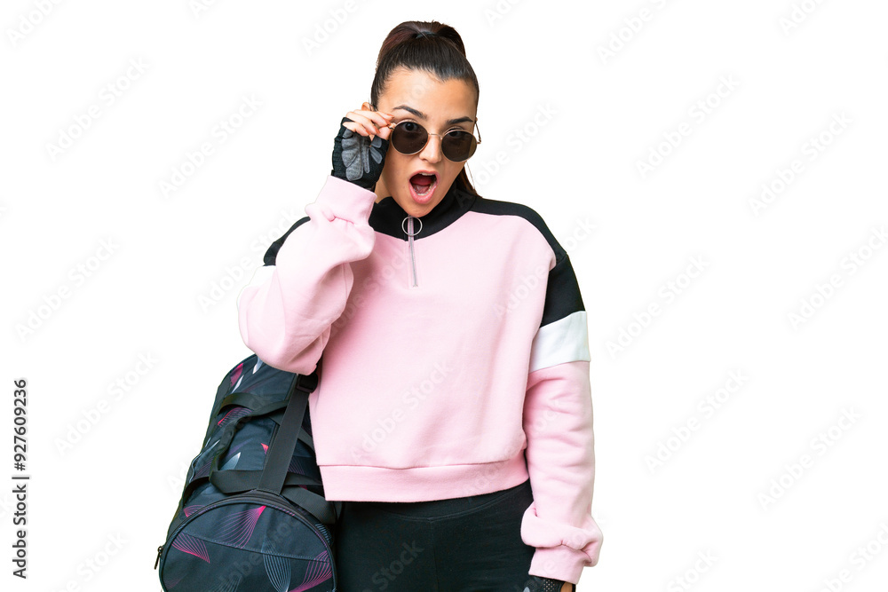 Young sport woman with sport bag over isolated chroma key background with glasses and surprised Young sport woman with sport bag over isolated chroma key background with glasses and surprised