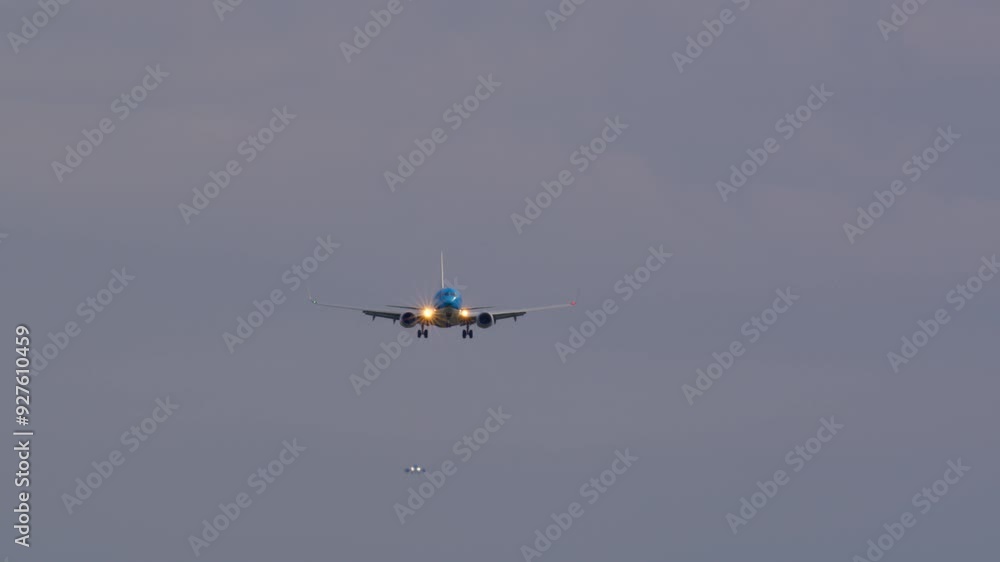 Large passenger plane is approaching the airport. The aircraft is descending with landing gear down and its flaps extended Large passenger plane is approaching the airport. The aircraft is descending with landing gear down and its flaps extended