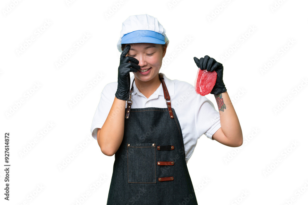 Young caucasian woman wearing an apron and serving fresh cut meat over isolated background laughing Young caucasian woman wearing an apron and serving fresh cut meat over isolated background laughing