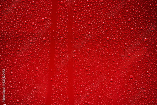 Bild auf Leinwand Closeup rain drops on red car with hydrophobic coating