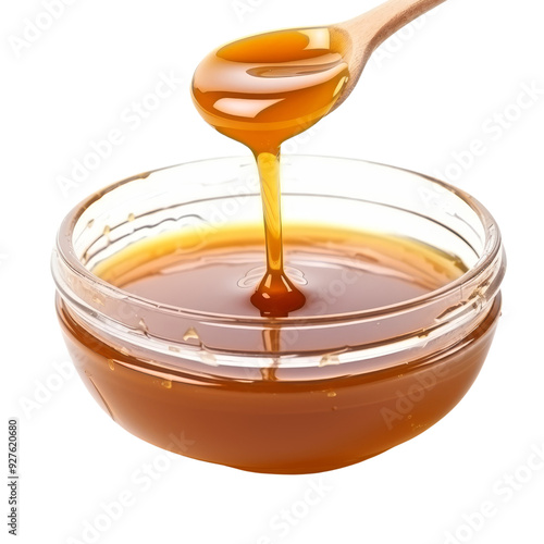 Golden Caramel Syrup Dripping from Spoon into Glass Bowl.