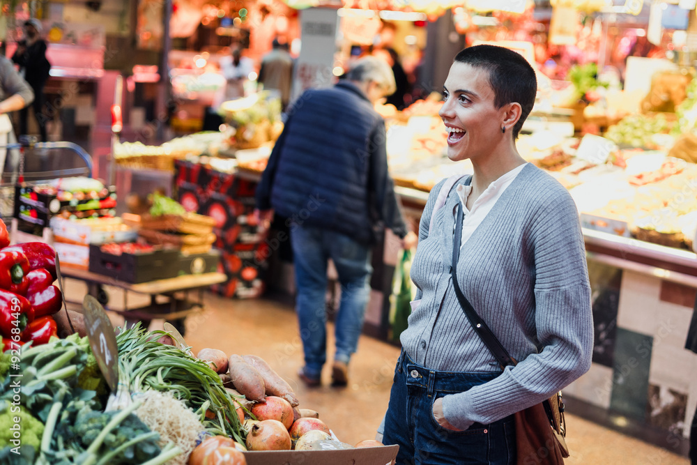 hispanic young woman with skinhead or short hair shopping vegetables and fruits on traditional market or grocery hispanic young woman with skinhead or short hair shopping vegetables and fruits on traditional market or grocery