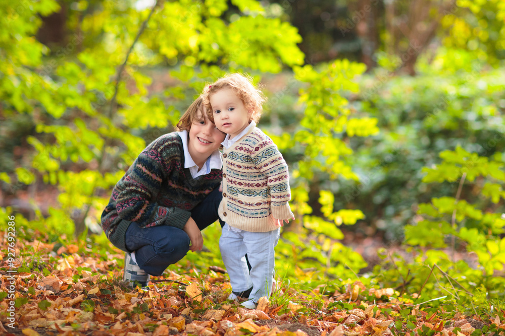 Kids play in autumn park Kids play in autumn park
