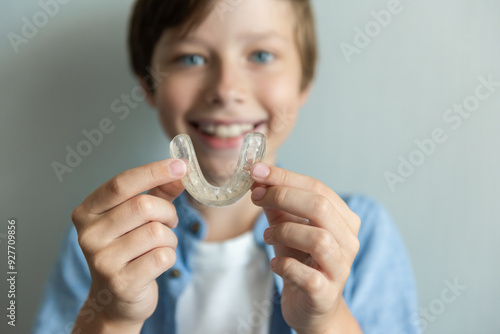 Smiling boy with braces and Invisalign and mouthguard concept. Orthodontic oral care for teenagers