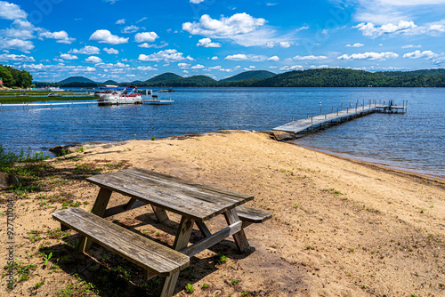 A bench on the beach on the Adirondack lake