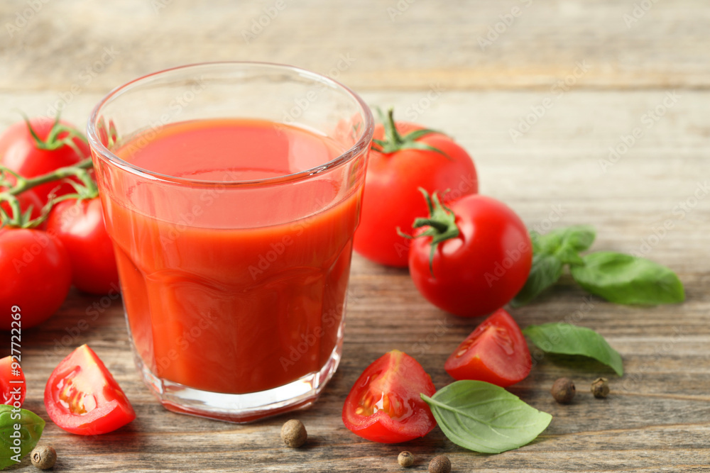 Tasty tomato juice in glass with fresh vegetables and spices on wooden table, closeup. Space for text Tasty tomato juice in glass with fresh vegetables and spices on wooden table, closeup. Space for text