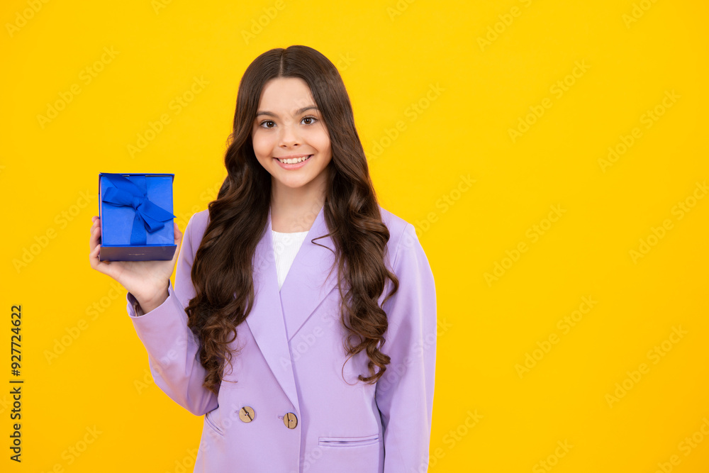Happy teenager, positive and smiling emotions of teen girl. Child with gift present box on isolated studio background. Gifting for kids birthday. Happy teenager, positive and smiling emotions of teen girl. Child with gift present box on isolated studio background. Gifting for kids birthday.