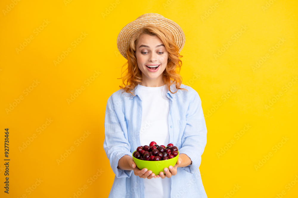 Young woman eats sweet cherries. Portrait of a beautiful girl with cherry on yellow background. Summer fruit picking season. Natural vitamins. Young woman eats sweet cherries. Portrait of a beautiful girl with cherry on yellow background. Summer fruit picking season. Natural vitamins.