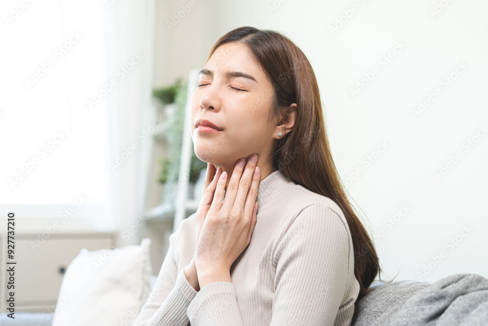 Sickness in inflaming asian young woman, girl use hand check self touch at sore throat, pain thyroid gland on neck or disease reflux, acid of suffer people at home. Medical and healthcare. Sickness in inflaming asian young woman, girl use hand check self touch at sore throat, pain thyroid gland on neck or disease reflux, acid of suffer people at home. Medical and healthcare.
