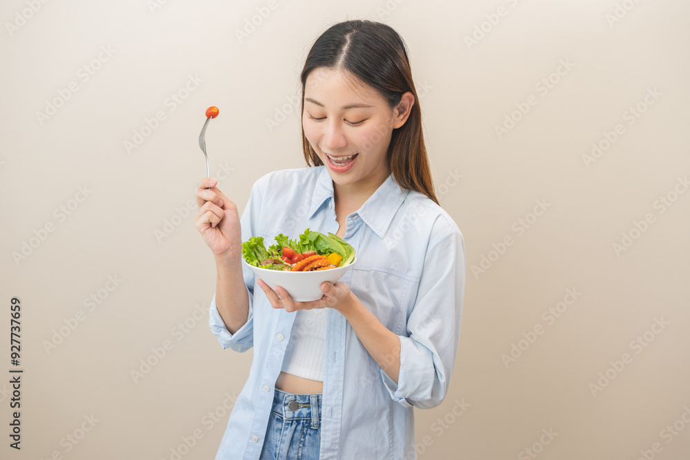 Diet concept, happy smile asian young woman use fork to prick tomato, fresh vegetable or green salad, eat nutrition food isolated on background, low fat to good body, getting weight loss for healthy. Diet concept, happy smile asian young woman use fork to prick tomato, fresh vegetable or green salad, eat nutrition food isolated on background, low fat to good body, getting weight loss for healthy.