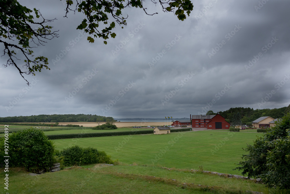 Obraz premium Green field with some buildings