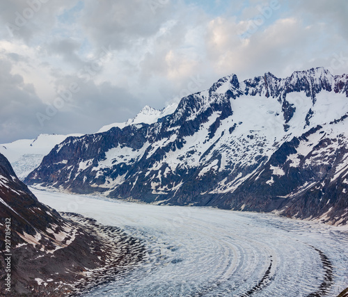 Great Aletsch Glacier and ice fall summer cloudy view (Bettmerhorn, Switzerland, Alps mountains) photo