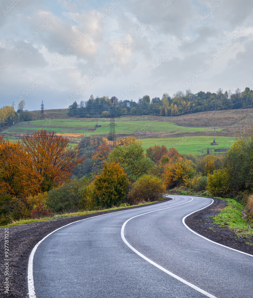Obraz premium Hazy and overcast Carpathian Mountains and highway on mountain pass, Ukraine.