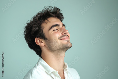 A close up of a man's face with his eyes closed