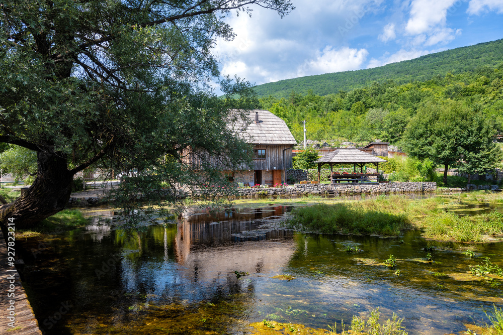 Wonderful Majerovo Vrilo, old mill houses and bridges made from wood and stone in the village of Sinac, Croatia, built around Gacka river source Wonderful Majerovo Vrilo, old mill houses and bridges made from wood and stone in the village of Sinac, Croatia, built around Gacka river source