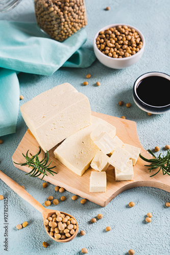 Obraz na płótnie Organic vegetarian soy tofu and rosemary on wooden board on table vertical view w salonie